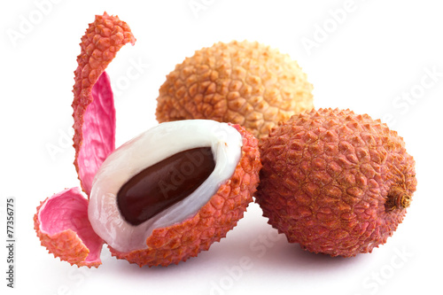 Litchis with pip, skin, and flesh. On white.