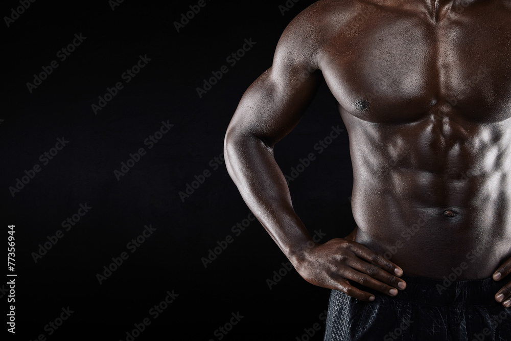 Close-up of shirtless african man with hands on hip