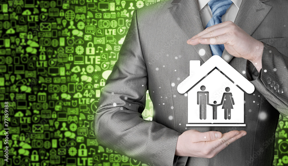 businessman protecting family in home with hands businessman protecting family in home with hands