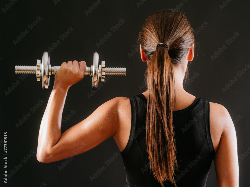 Female doing shoulder press with dumbbell