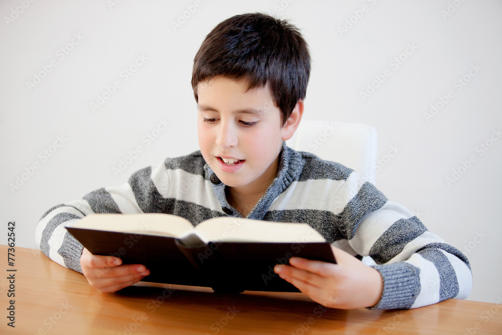 Concentrated teenage boy of thirteen reading a book Concentrated teenage boy of thirteen reading a book