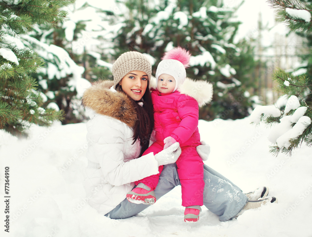Happy mother and child having fun outdoors near christmas trees Happy mother and child having fun outdoors near christmas trees