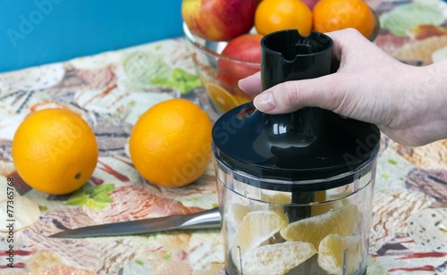 Preparation of blender to mix the oranges. photo