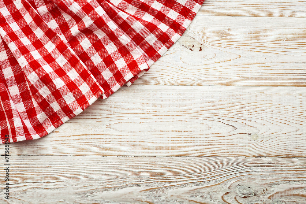 Top view of checkered tablecloth on white wooden table. Top view of checkered tablecloth on white wooden table.