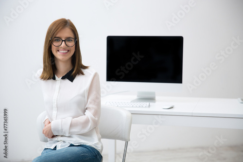Happy smiling business woman in glasses at office