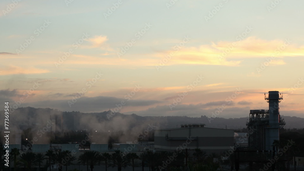 Time lapse shot of an industrial power plant during sundown Time lapse shot of an industrial power plant during sundown