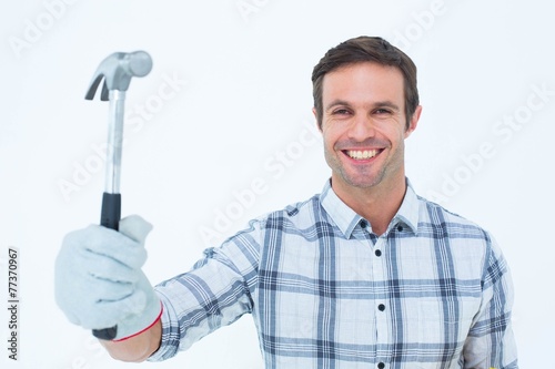 Happy handyman holding hammer