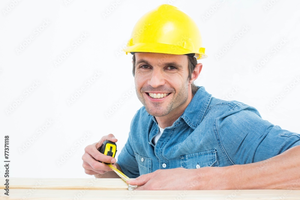 Male carpenter using measue tape Male carpenter using measue tape