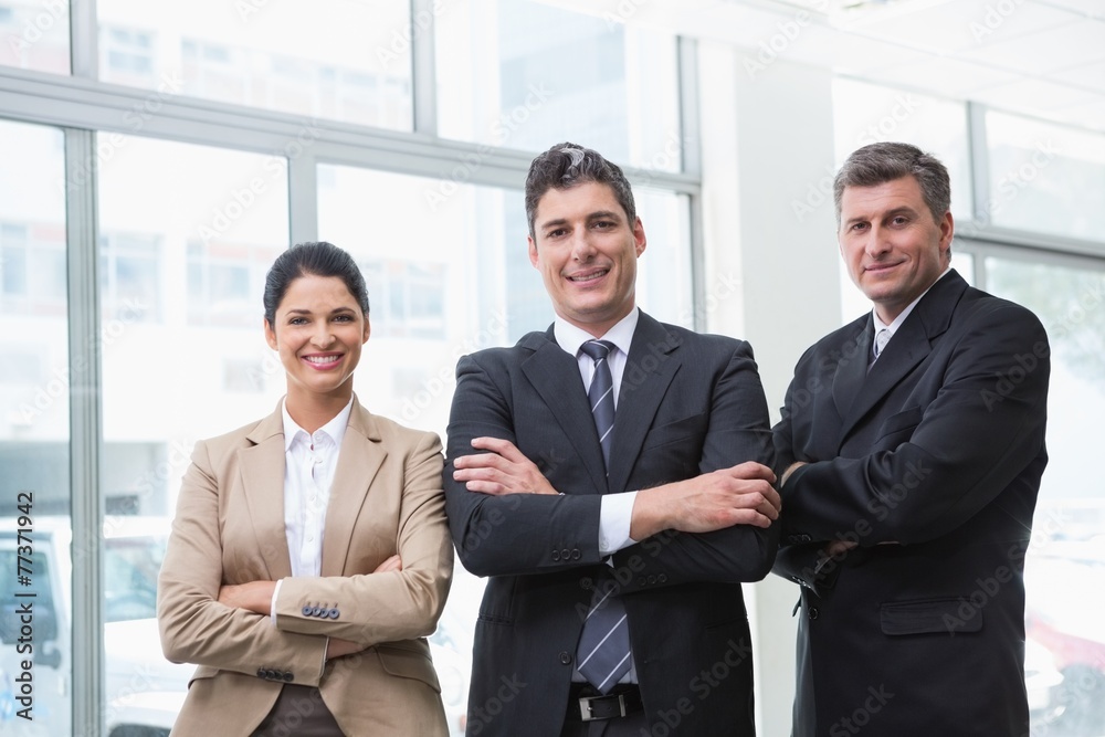 Smiling business team standing with arms crossed Smiling business team standing with arms crossed