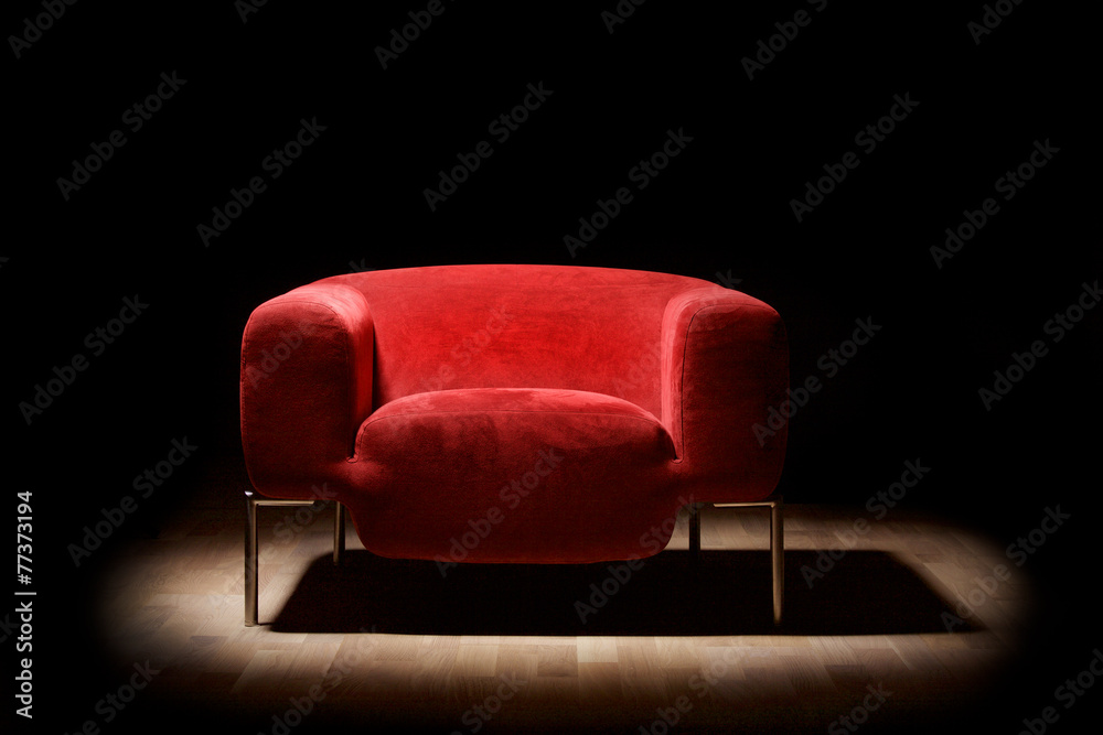 Red alcantara armchair on a black background - obrazy, fototapety, plakaty 