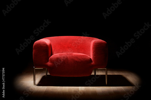 Red alcantara armchair on a black background photo
