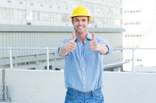 Male architect showing double thumbs up