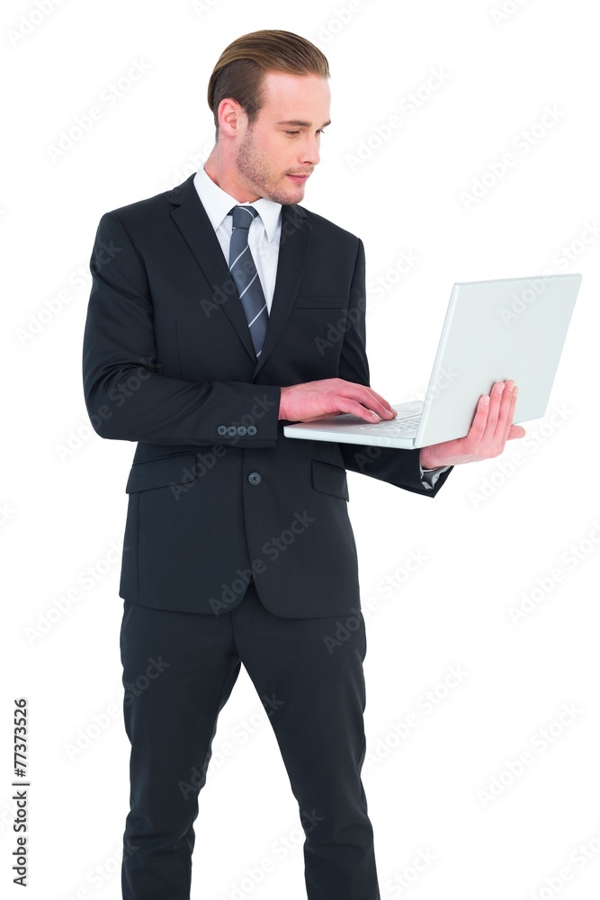 Businessman in suit typing on laptop Businessman in suit typing on laptop