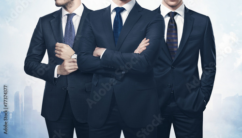 Three businessmen on megalopolis background