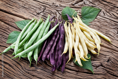 Fresh green beans on the old wooden table. photo