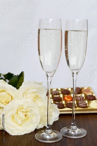 Champagne Glasses, Box of Chocolate and Bunch of White Roses