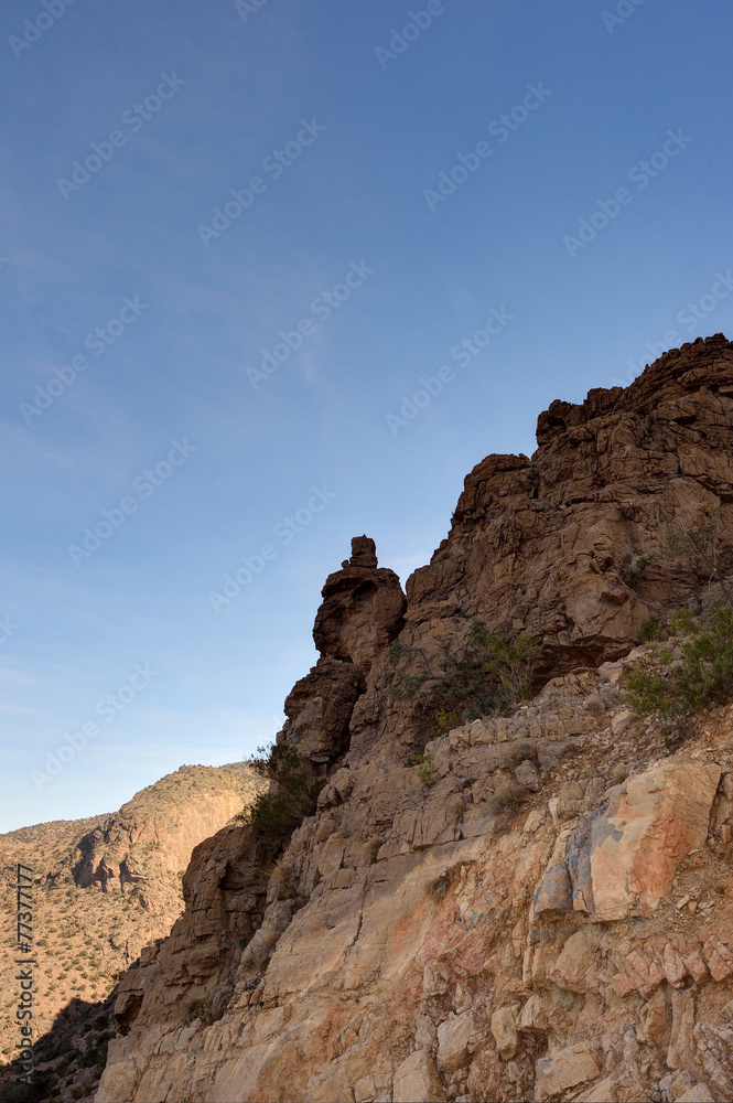 Rocky cliff with blue sky, Jabal Nakhal, Sultanate of Oman