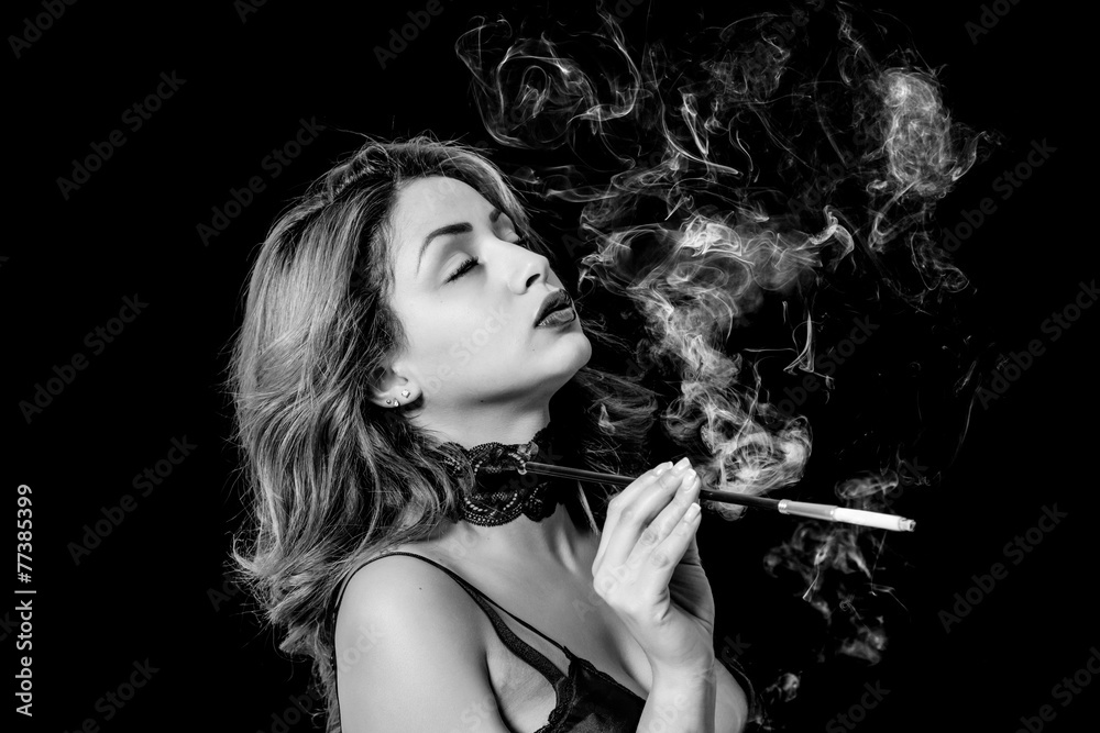 Sexy woman with cigarette holder smoking black and white Stock Photo