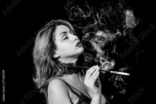 Sexy woman with cigarette holder smoking black and white