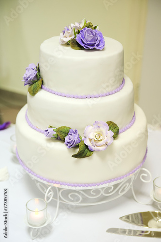 Wedding cake decorated with beautiful flowers.