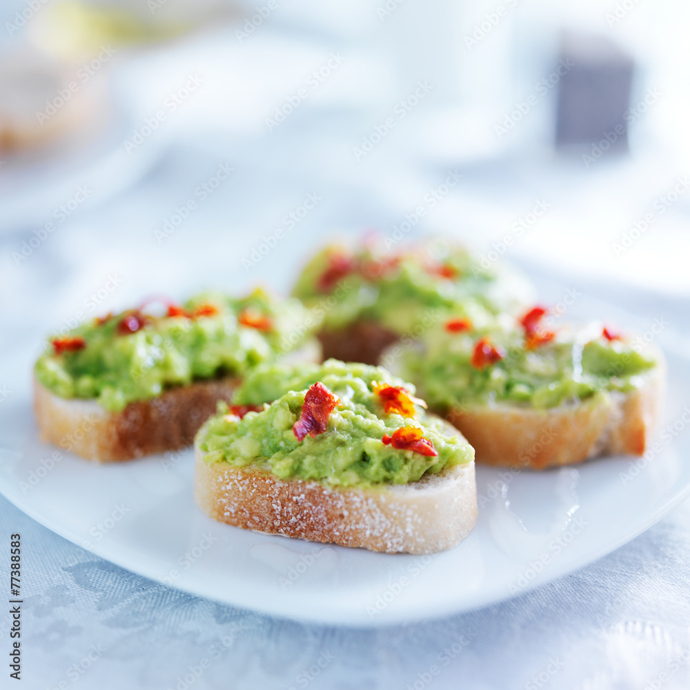 spicy avocado spread on toasted crustini