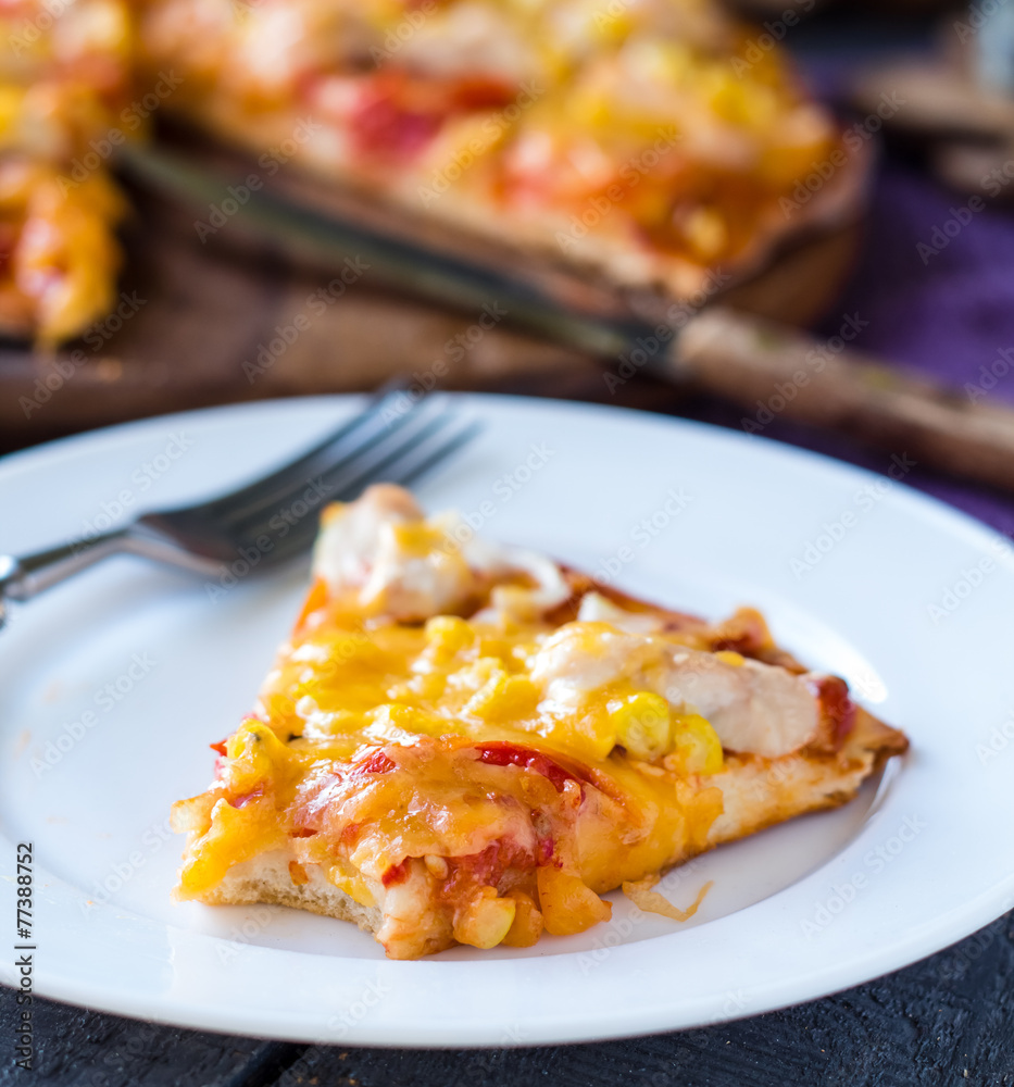 slice of pizza with chicken, corn, tomatoes and double cheese slice of pizza with chicken, corn, tomatoes and double cheese