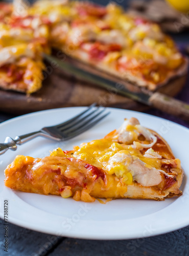 slice of pizza with chicken, corn, tomatoes and double cheese