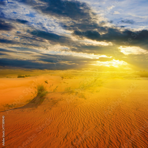 dramatic sunset over a sandy desert