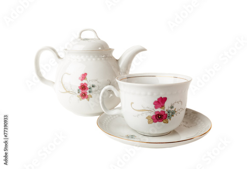 Porcelain teapot, teacup and saucer on white