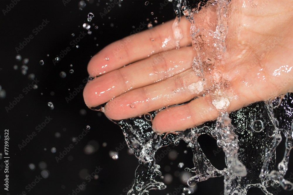 Fototapeta premium hand in water on a black background