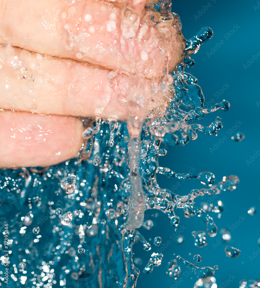 Fototapeta premium fingers in water on a blue background