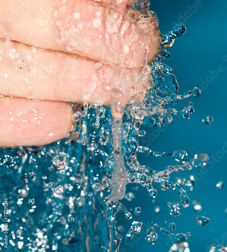 fingers in water on a blue background