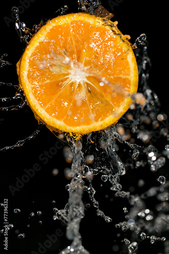 orange in water on a black background