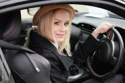 Attractive blond woman at the wheel of her car