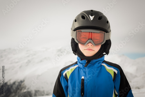 Young skier on winter background