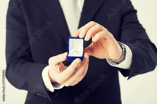 man with gift box and wedding ring