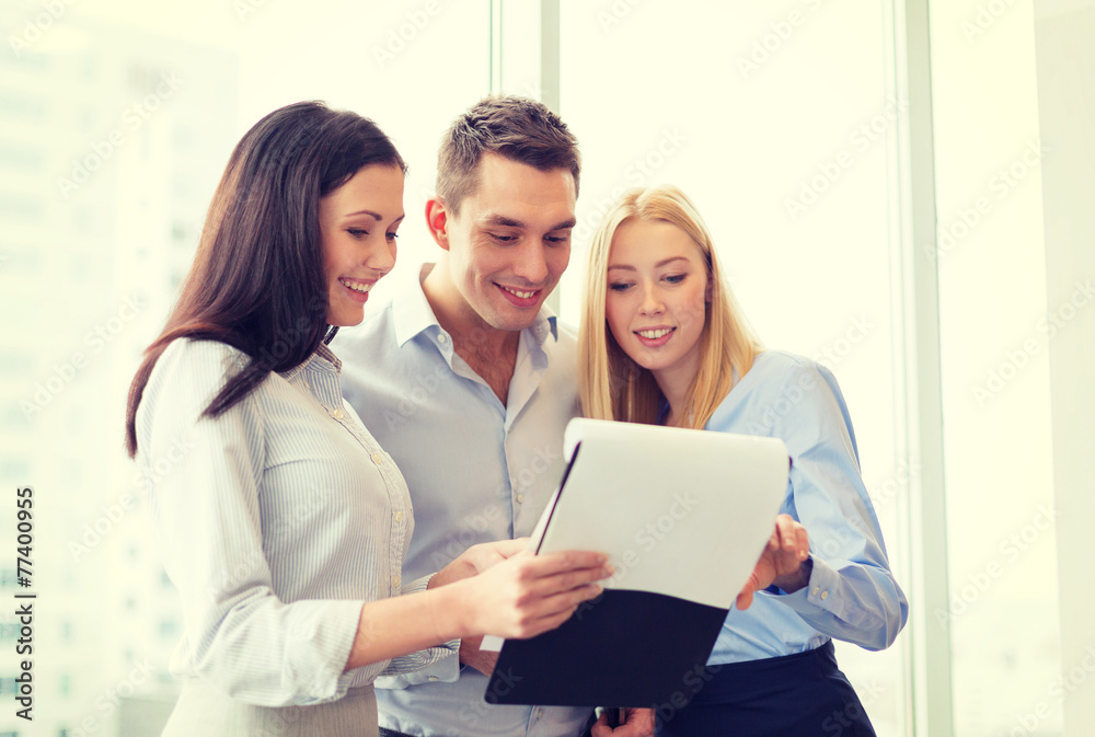 business team looking at clipboard business team looking at clipboard