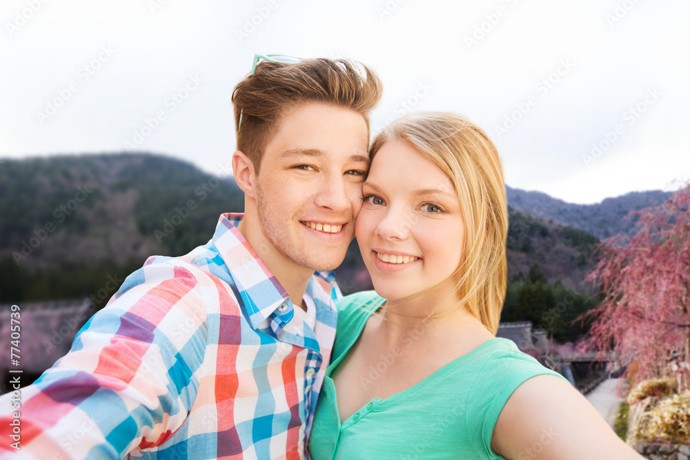 smiling couple taking selfie over asian landscape smiling couple taking selfie over asian landscape