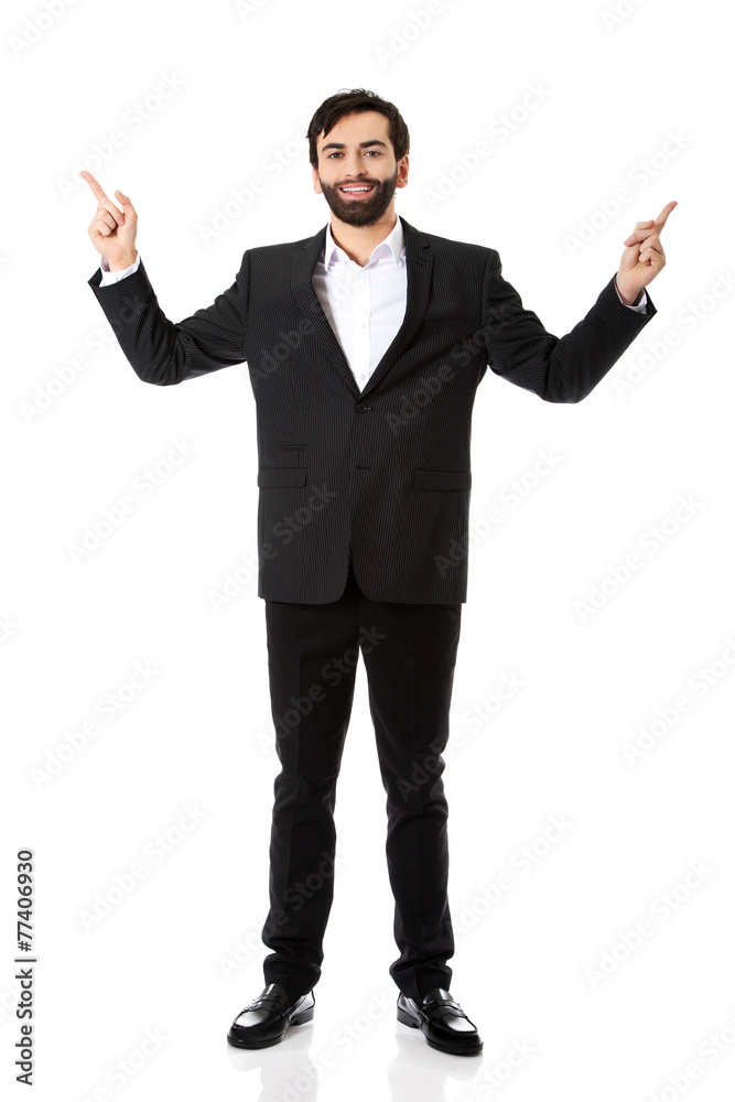 Happy businessman points his finger up. Happy businessman points his finger up.