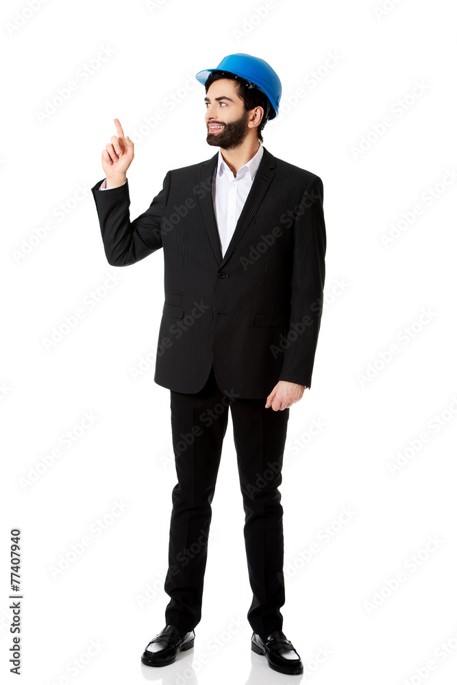 Engineer in protective helmet pointing up. Engineer in protective helmet pointing up.
