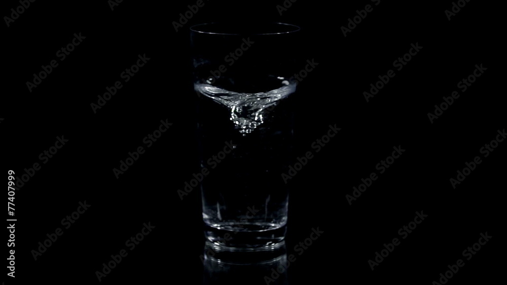 Making a small whirlpool in the middle of the glass with a straw Making a small whirlpool in the middle of the glass with a straw