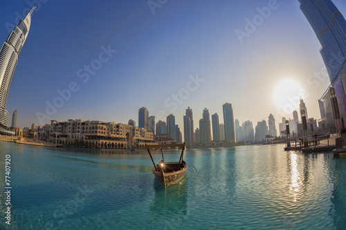 Photography Dubai lagoon with boat against sunset in UAE