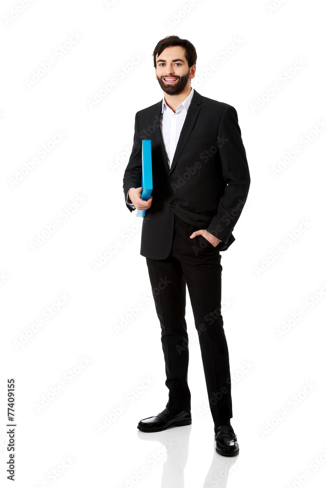 Handsome businessman holding a binder. Handsome businessman holding a binder.