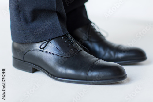 close up of man legs in elegant shoes with laces © Syda Productions