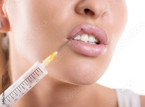cosmetic injection to the lips of a beautiful woman