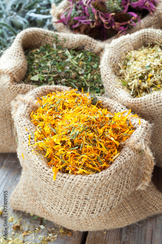 Healing herbs in hessian bags, herbal medicine.