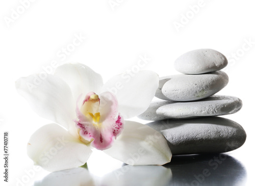 Still life of spa stones on glossy surface isolated on white