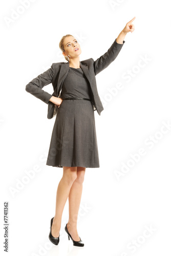 Businesswoman pointing high