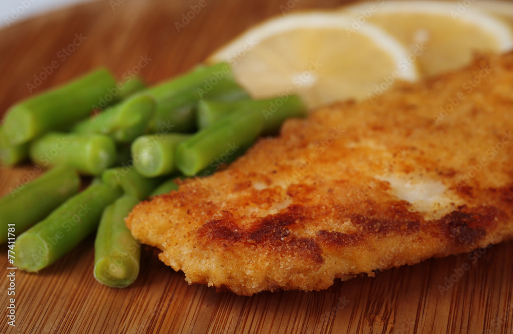 Breaded fried fillet and potatoes with asparagus and sliced Breaded fried fillet and potatoes with asparagus and sliced
