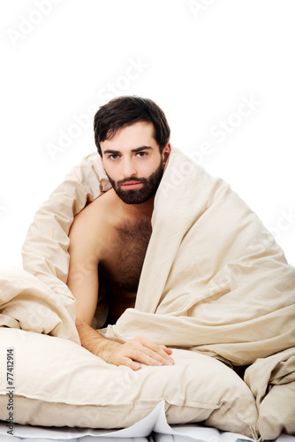 Man waking up in bed.